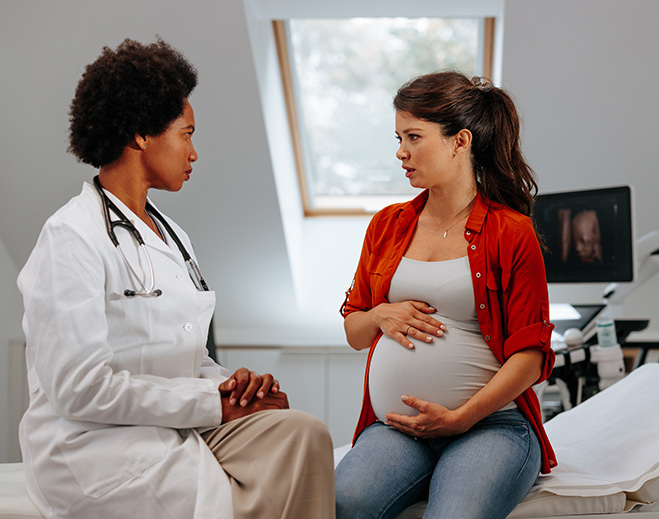 Healthcare provider consulting pregnant patient
