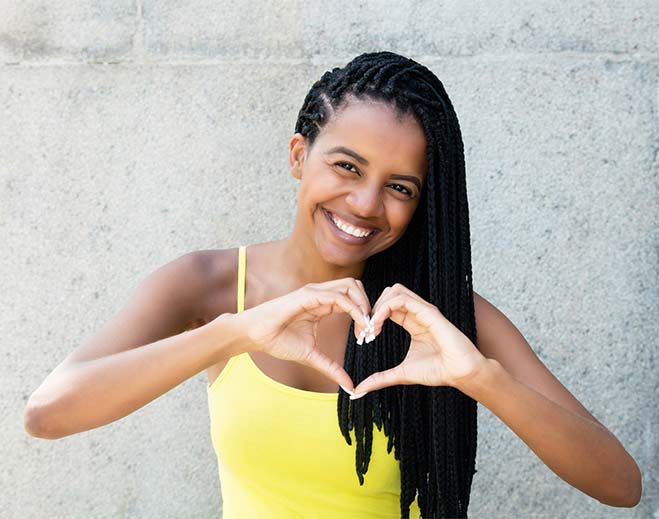 Person making heart shape with hands