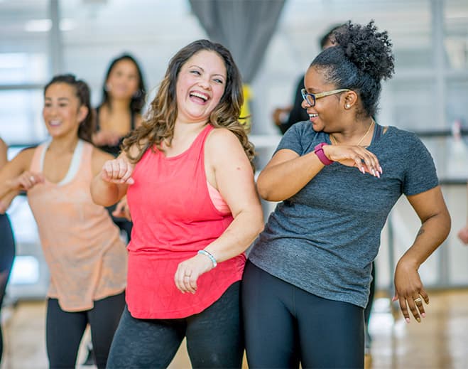 Group participating in energetic fitness dance class
