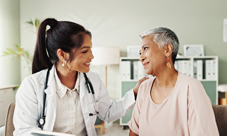 Doctor comforting patient during consultation