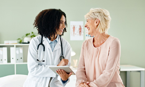 Doctor consulting patient with tablet