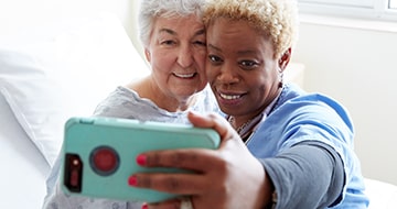 Nurse taking selfie with patient