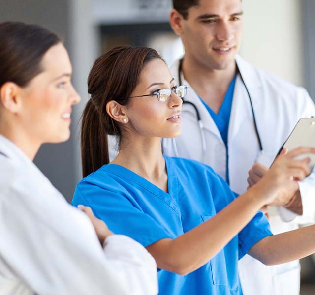 Healthcare workers reviewing information on tablet
