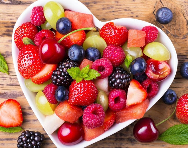 Heart-shaped bowl of fresh mixed fruit