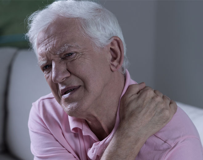 Older adult holding shoulder in pain