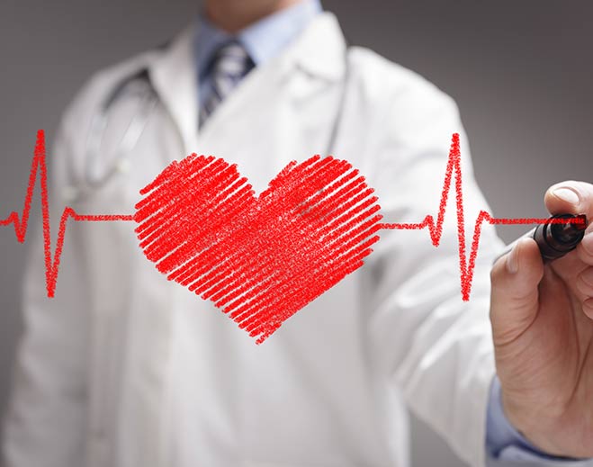 Doctor drawing red heart with ECG line