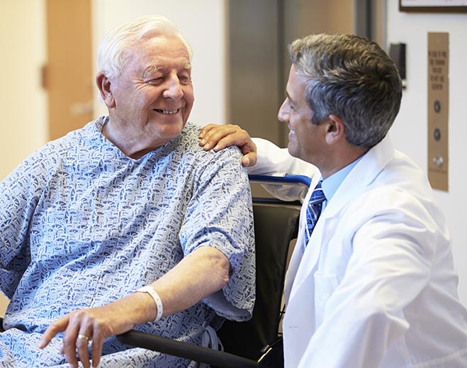 Doctor speaking with patient in hospital room