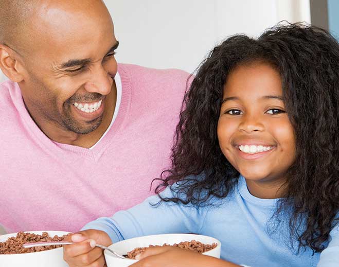 Parent and child sharing breakfast together