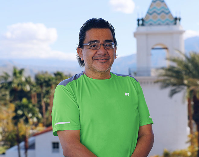 Man outdoors near tower and mountains