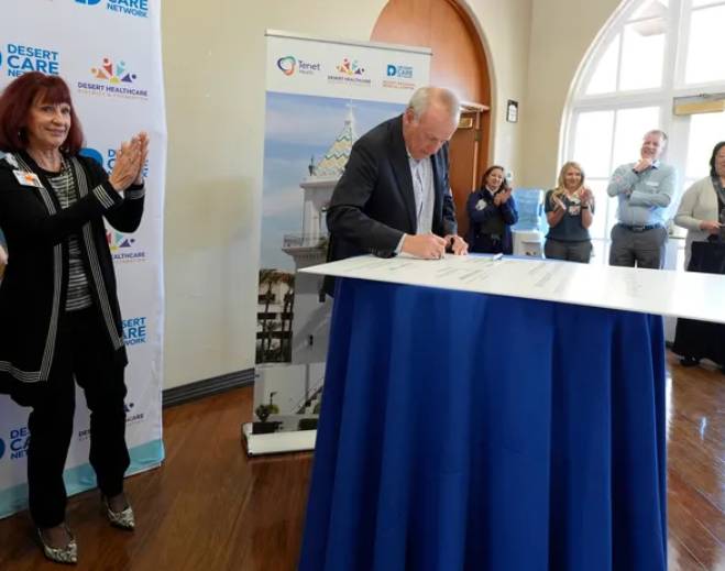 Leader signing document at ceremony