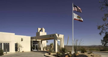 Healthcare facility exterior with flags and entrance