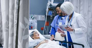 Doctors checking on patient in hospital room