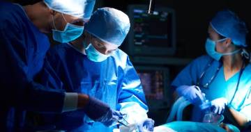 Surgical team performing operation in theater